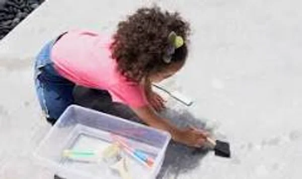 Child water painting on pavement